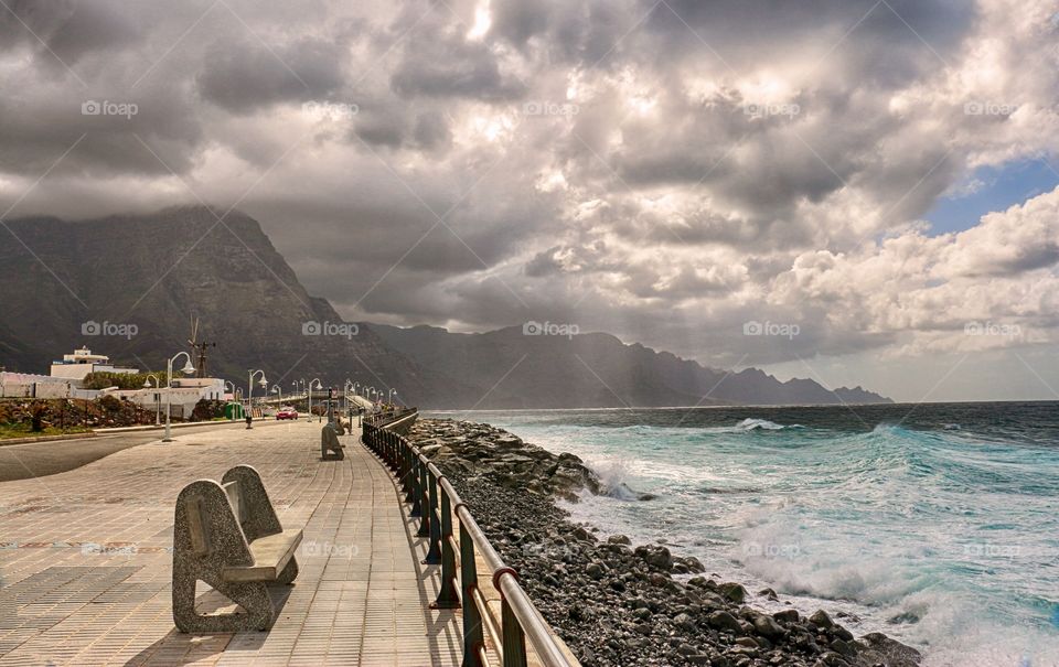 View of coastline, ocean and sun beam trough the clouds in Puerto de Las Nieves, Gran Canaria, Spain