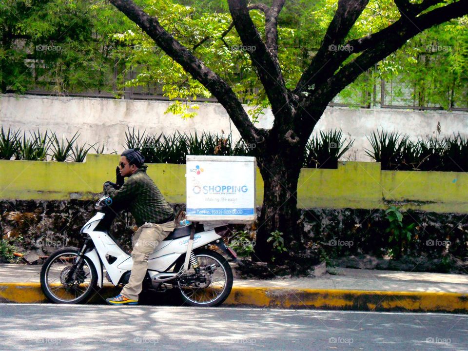 motorcycle rider stopped to call on cellphone