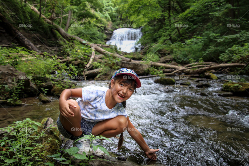 Cute little girl near a forest river