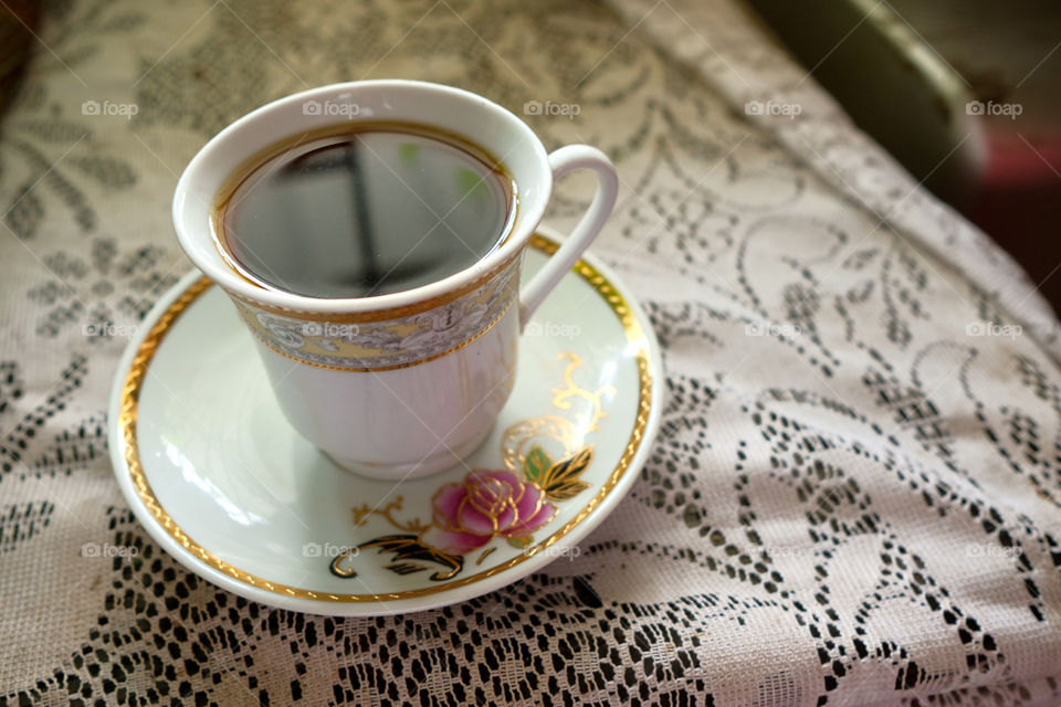 White coffee cup on white table