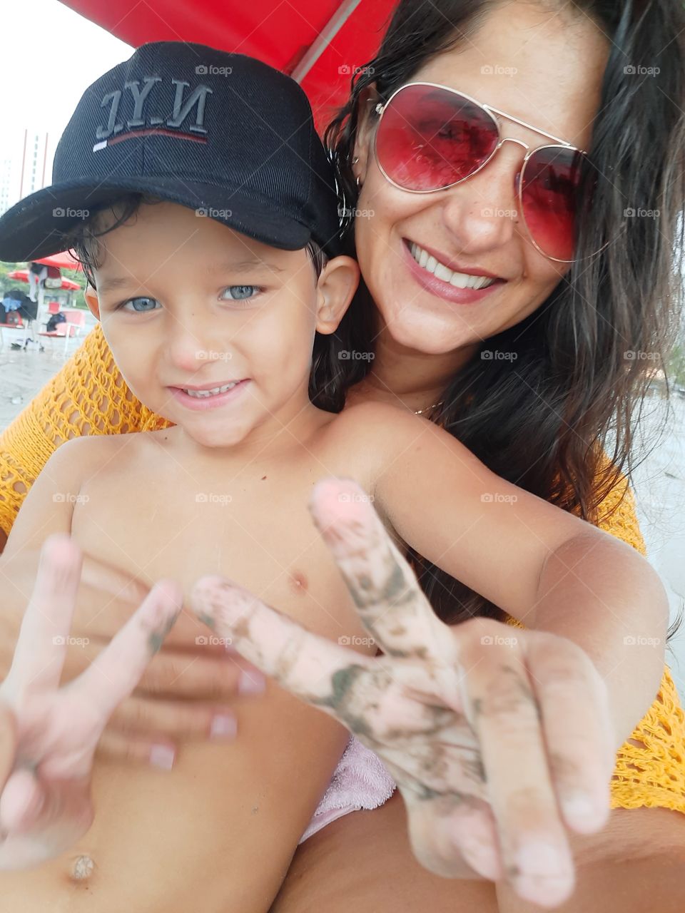 smiling woman and son on the beach in Santos