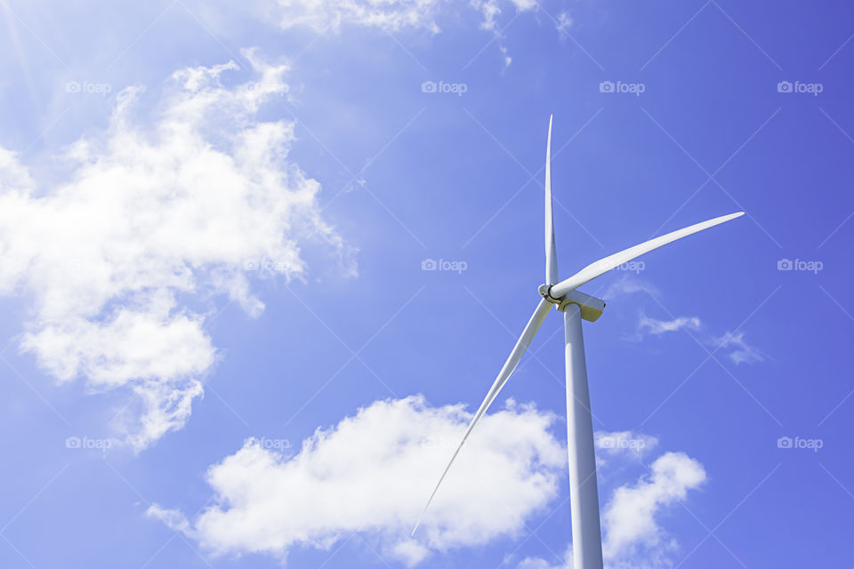 Wind turbines generate electricity and the bright blue sky at Khao Kho of phetchabun in Thailand.