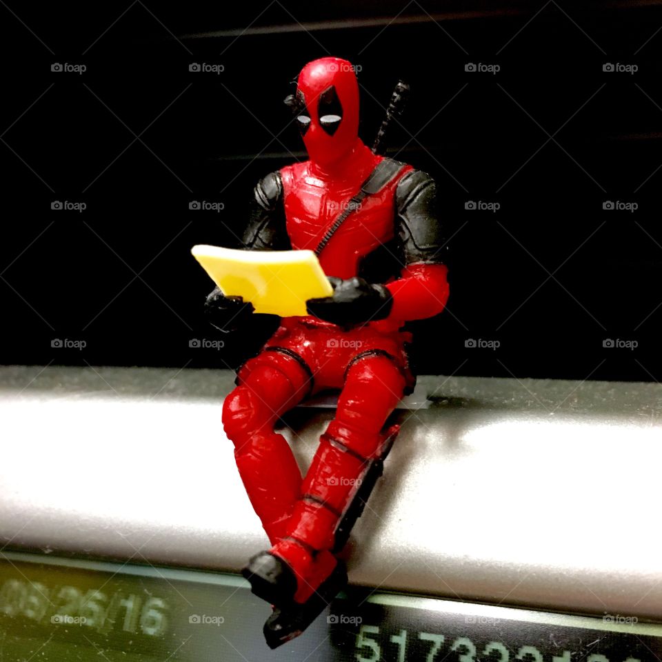 Deadpool sitting on a phone
