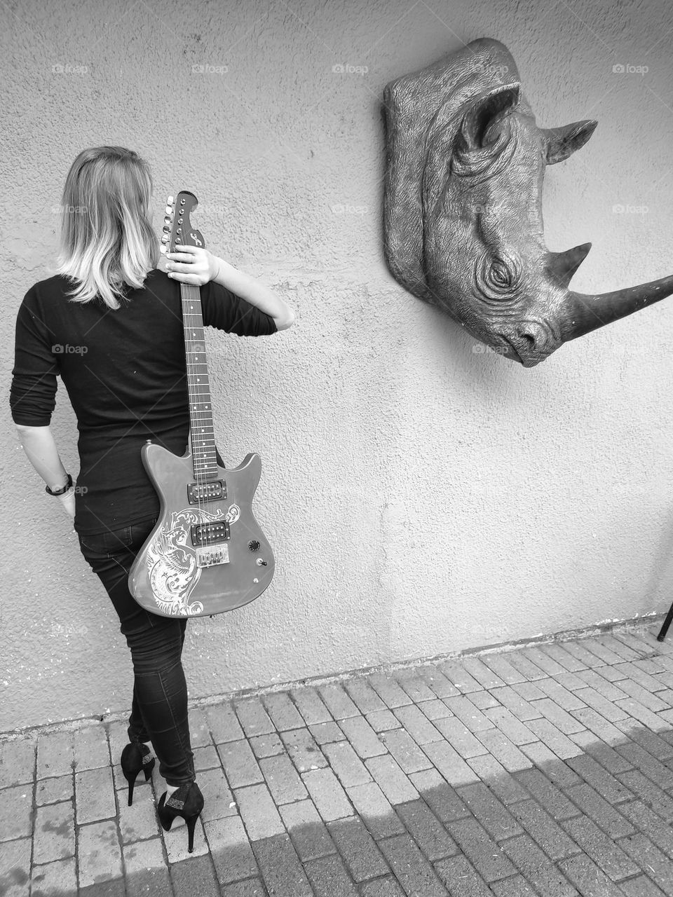 Female holding Electric Guitar