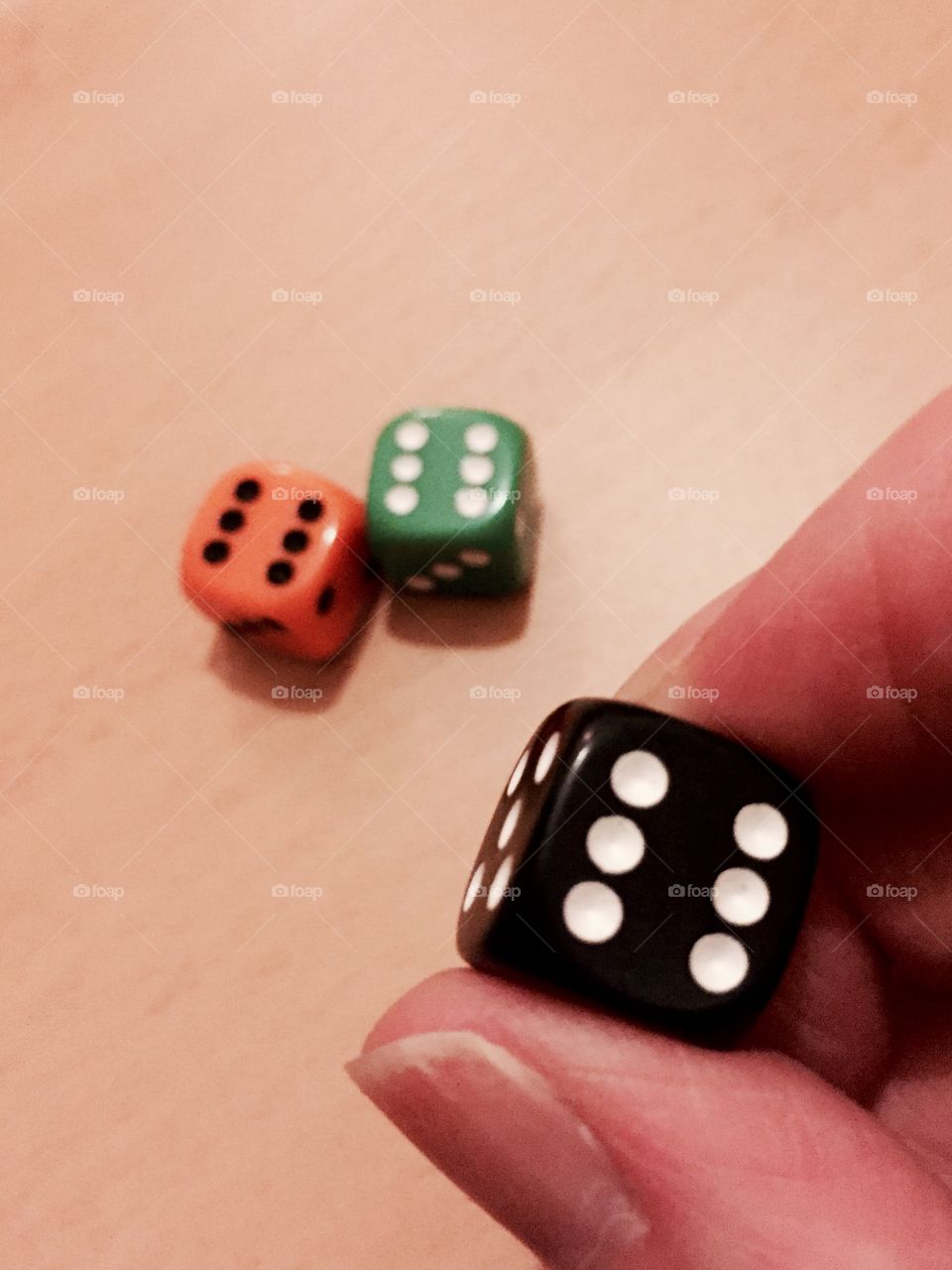 Person holding black dice