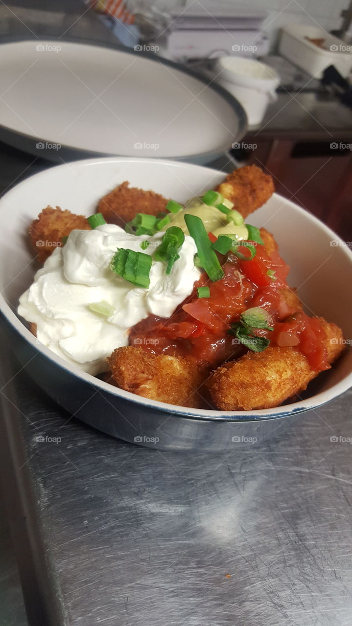 loads halloumi fries, topped with homemade salsa, guacamole and sour cream. finished with a sprinkle of spring onion.