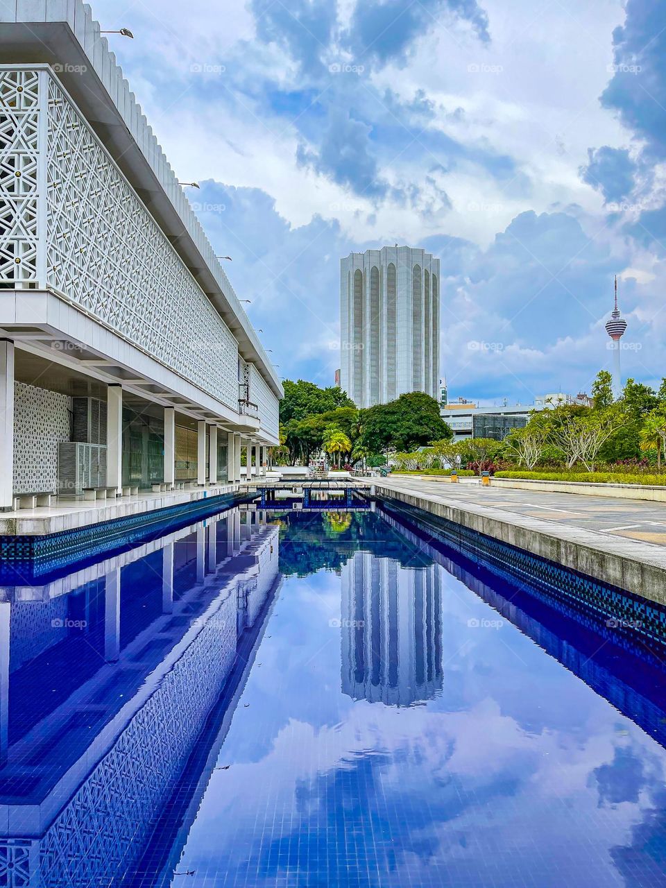 Reflection of buildings in the clear water in a pond