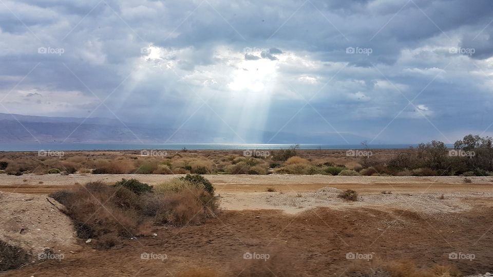 sun rays from the sky touching the sea