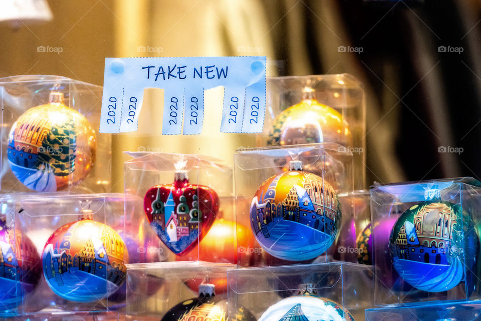 Christmas shop window with paper with the phrase: Take New and with a 2020 sign ready to be tore off