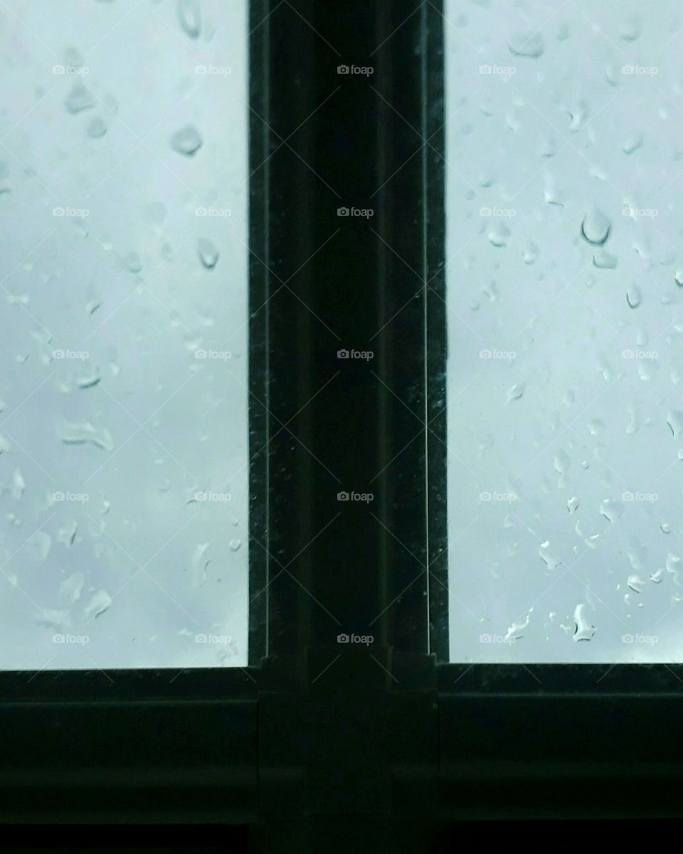 Foggy window with raindrops