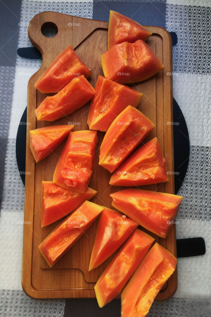 Slice of papaya fruits on cutting board