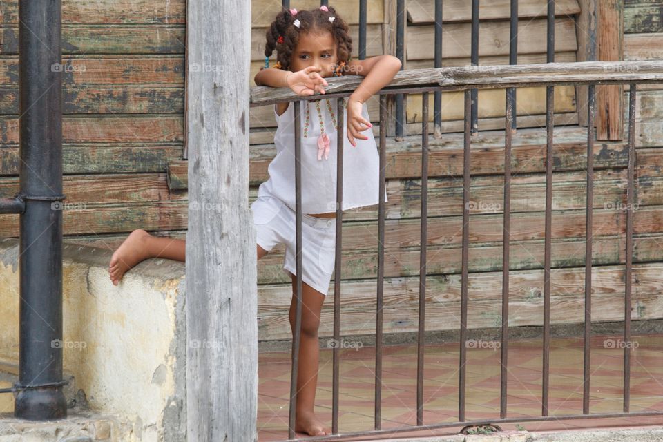 Cuban People.Little girl on the front porch of her house.