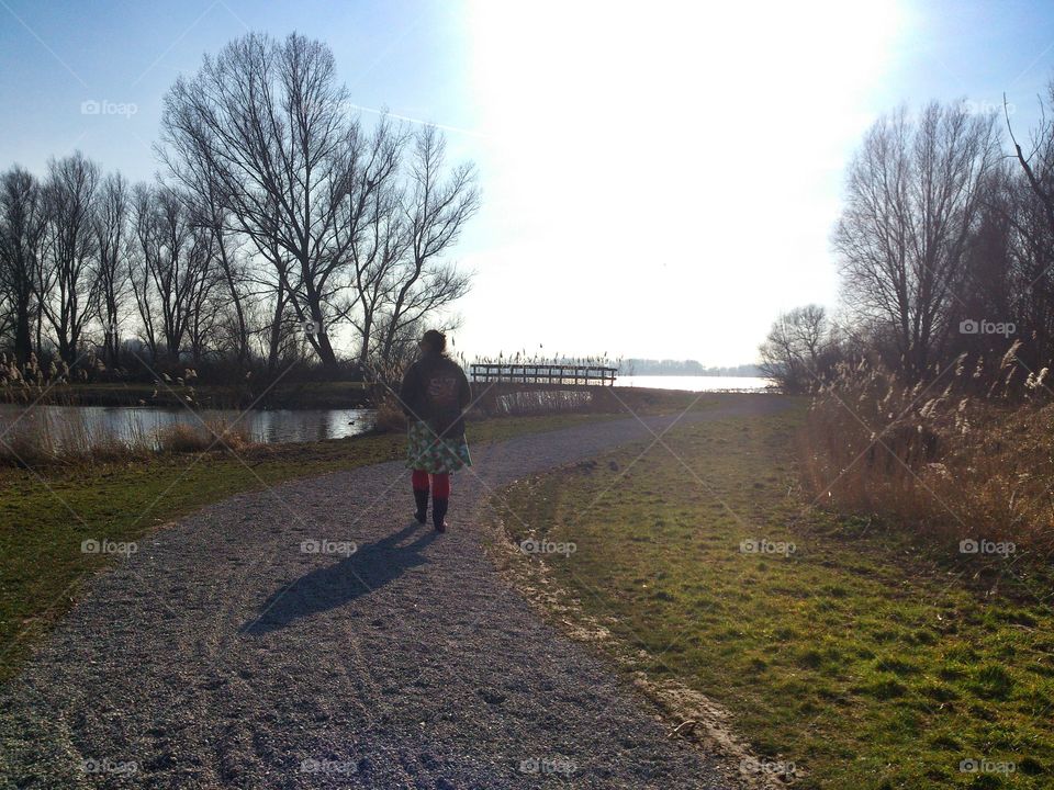 Taking in nature . Woman having a stroll in 'De Vlietlanden', near Leiden, the Netherlands 