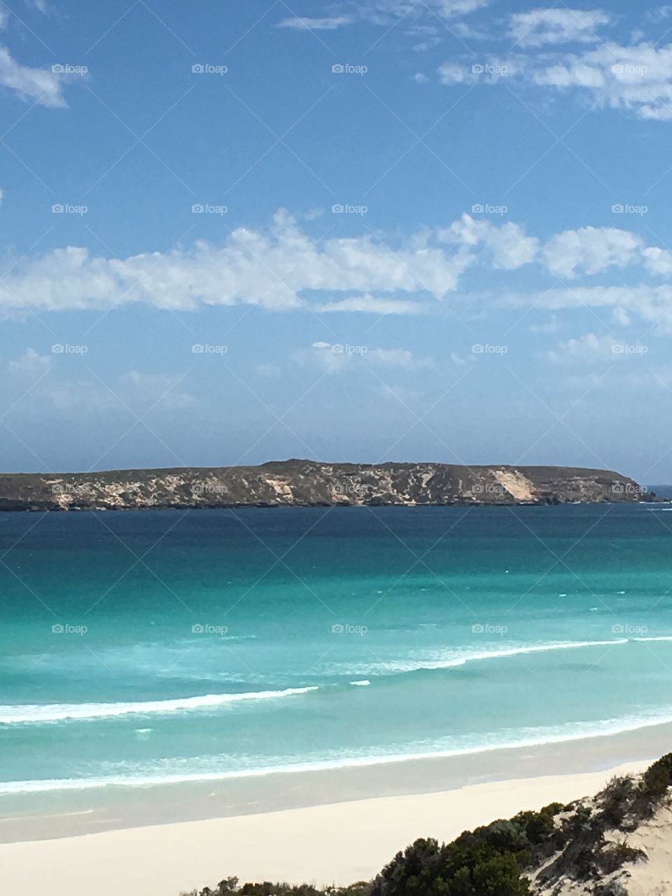 Island off the south Australian coast view from awesome remote beach with turquoise blue ocean and reefs