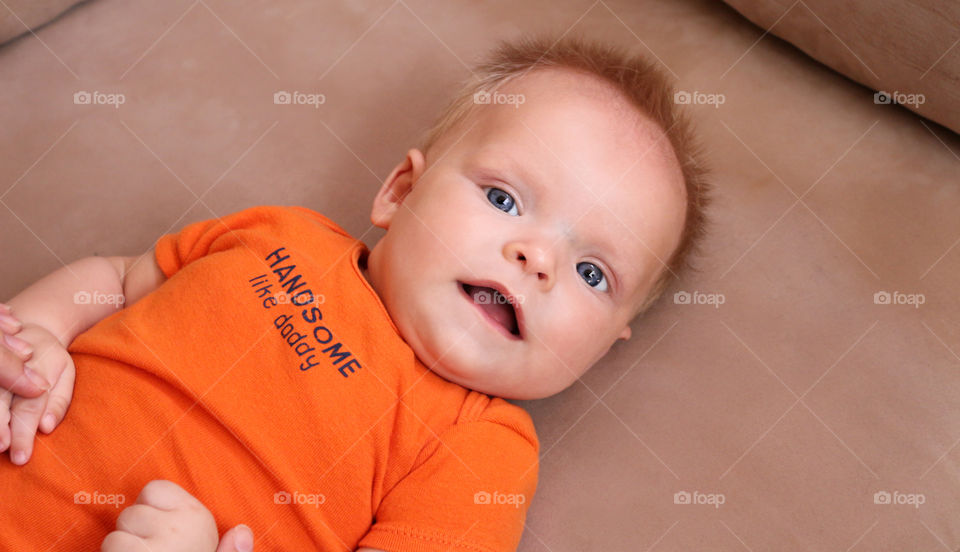 Cute baby boy looking at the camera 
