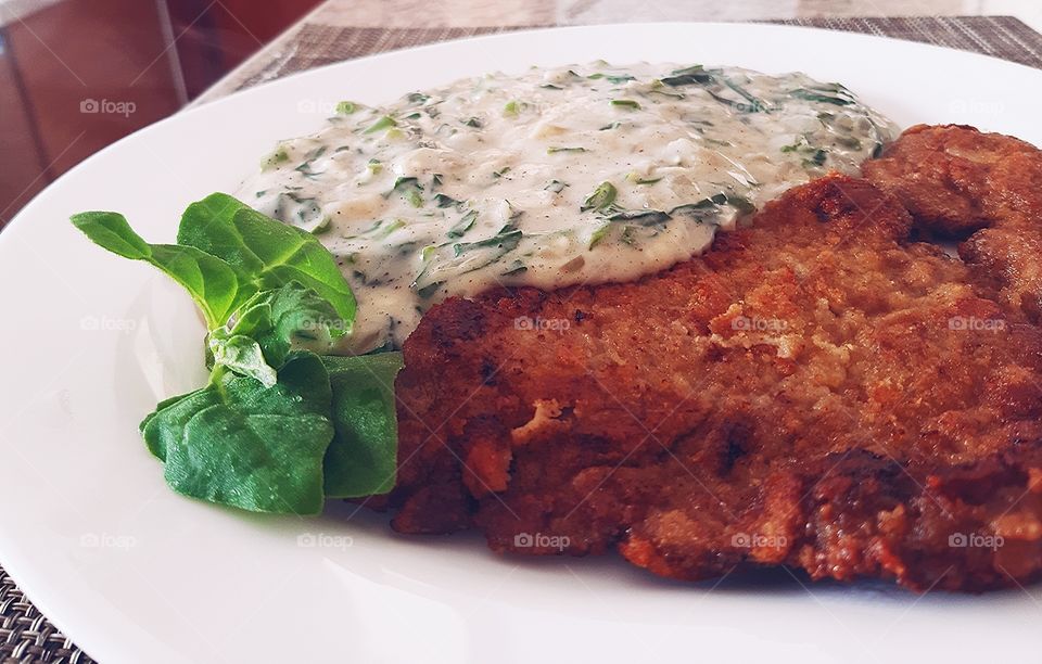 Breaded steak and spinach cream.