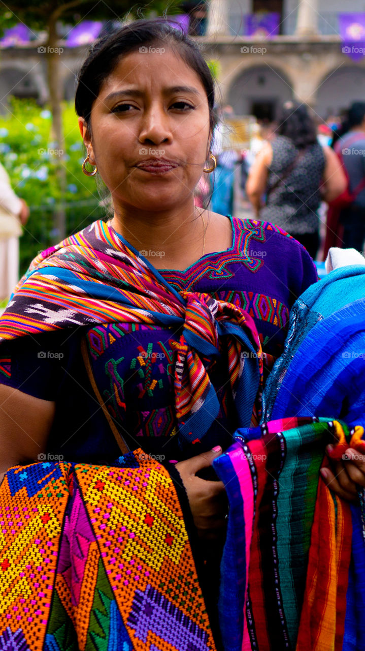 Young Guatemalteca selling clothes in the street in Antigua Guatemala