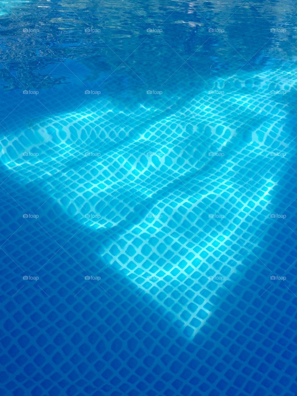 Light hitting the swimming pool as we were in  showing an almost heart shape in the water. 