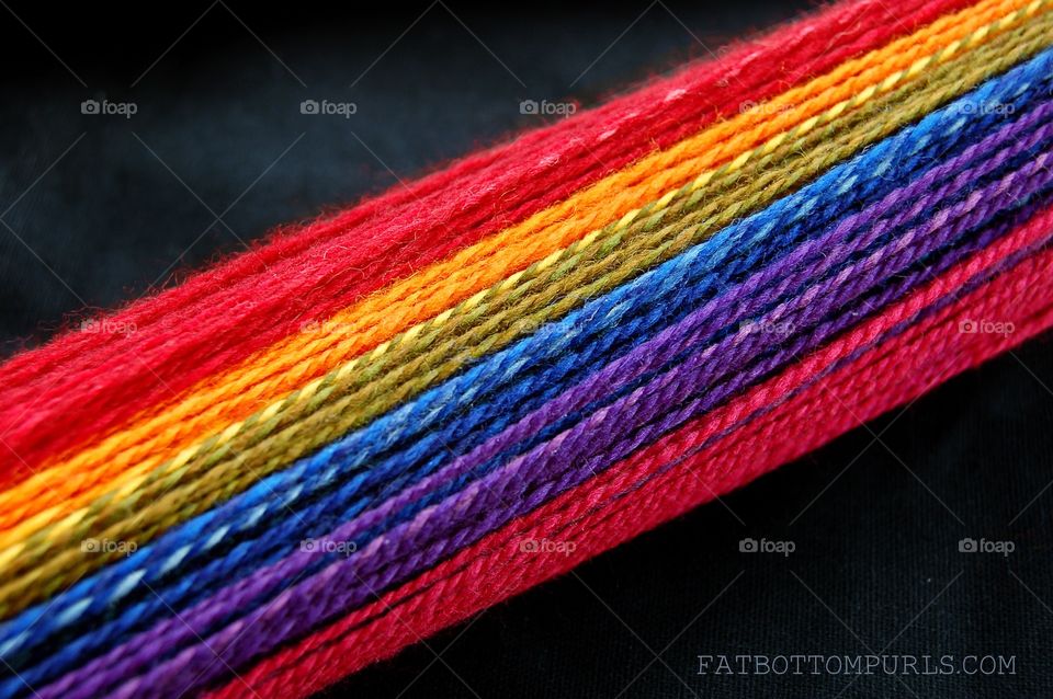 Rainbow in the Dark. Rainbow yarn on a black background. 