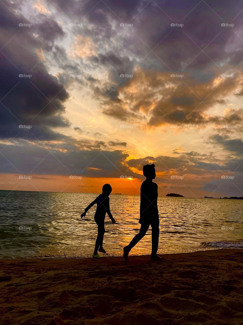 Vacation series: beaches; beach stroll at sunset 