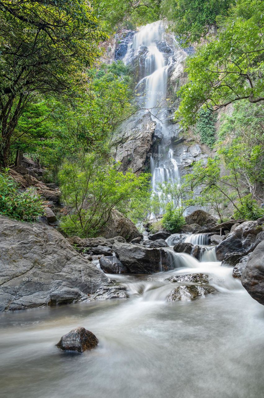 Long shot of beautiful waterfall in Thailand