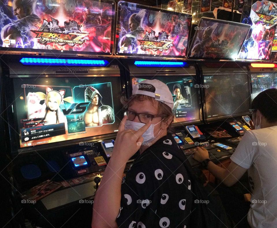 A girl playing video games (tekken) in japan 