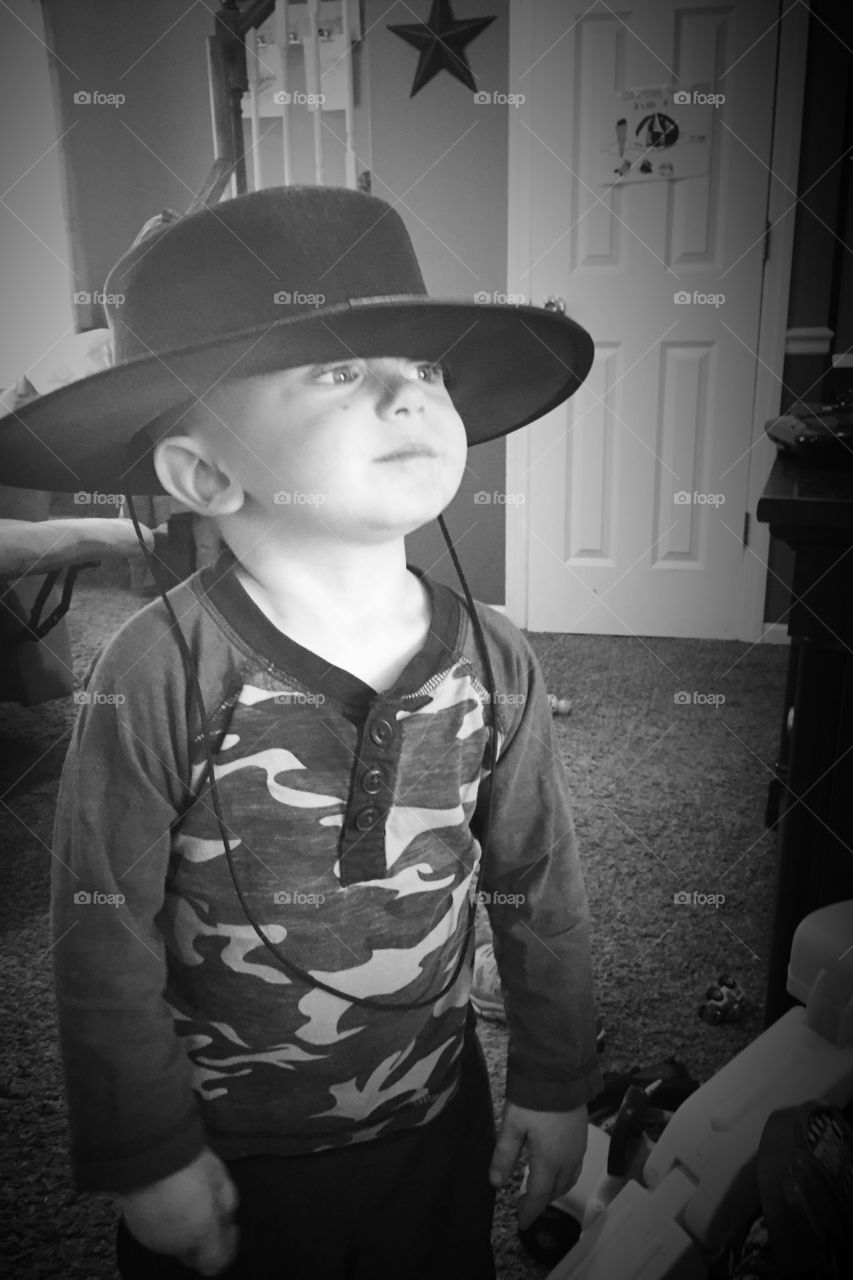 Little boy wearing hat at home