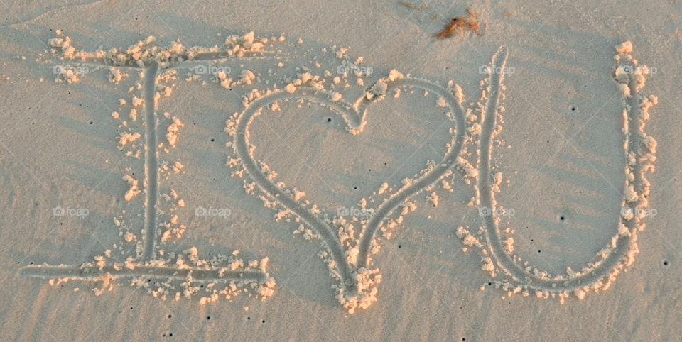 I Love You written in sand at the beach