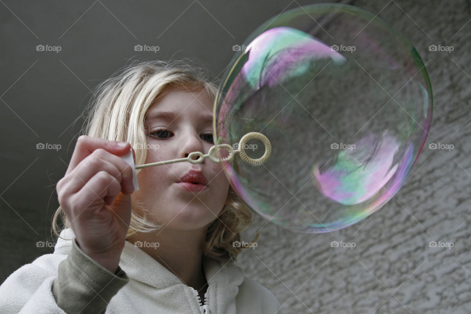 balloon girl. girl blowing a soap balloon