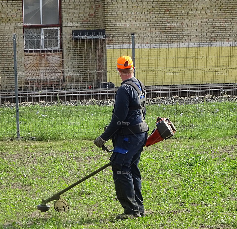 People at work. Grass cutter lawnmower   man