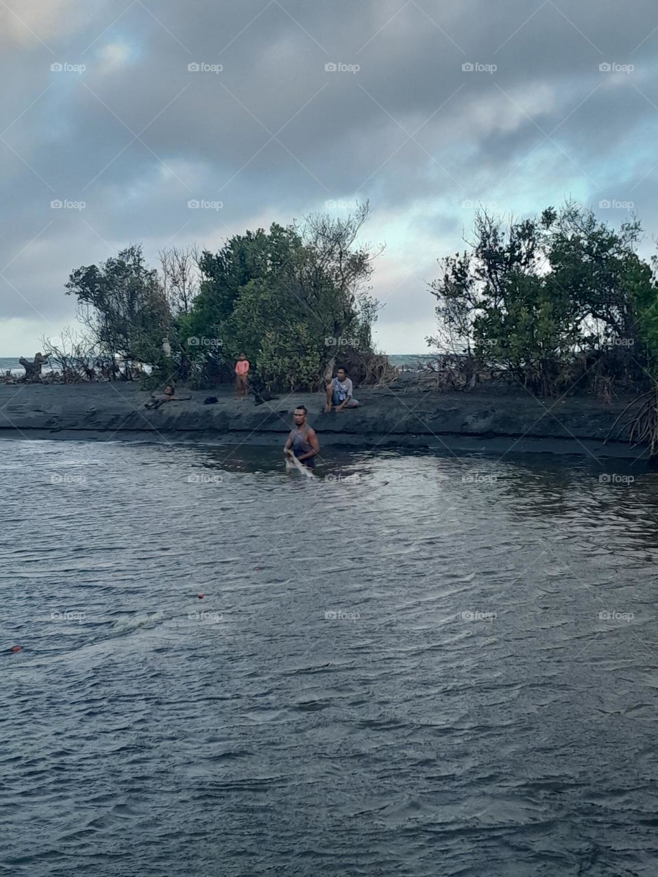 My brother teaching them how to fish using the gill net