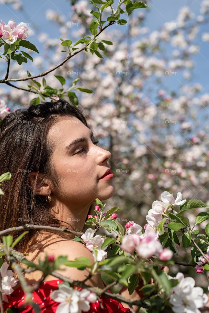 beautiful woman in spring blossom trees