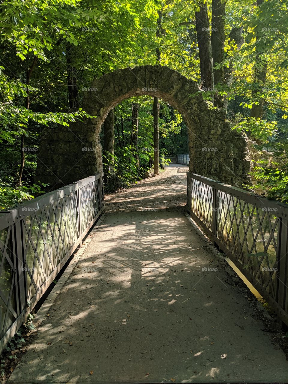 old stone Arch archway in German European Park Forest on castle grounds summer vacation
