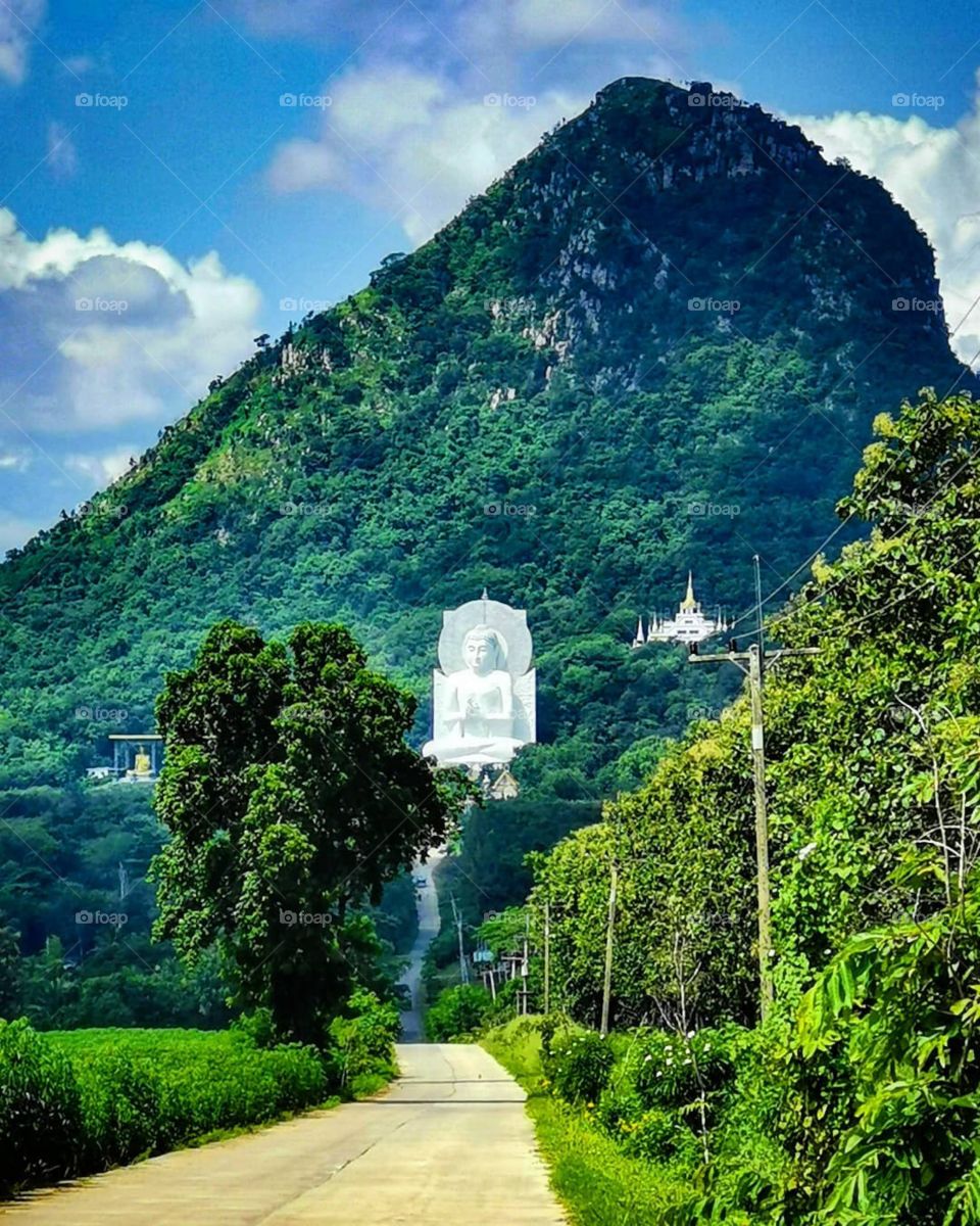 A Buddhist temple rests on a hillside in Lopburi, Thailand. That's definitely a sight you don't see every day!