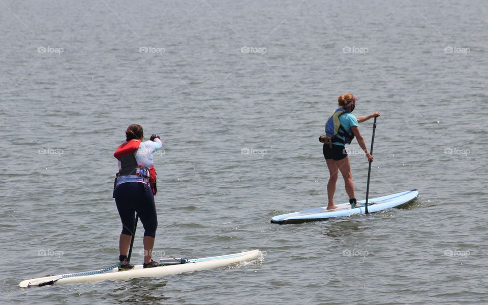 Two female paddleboarders on Hudson River in June