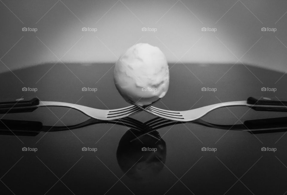 Forks and egg in reflection