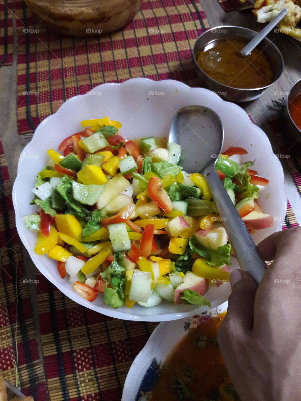 fresh vegetable salad hand serve with spoon