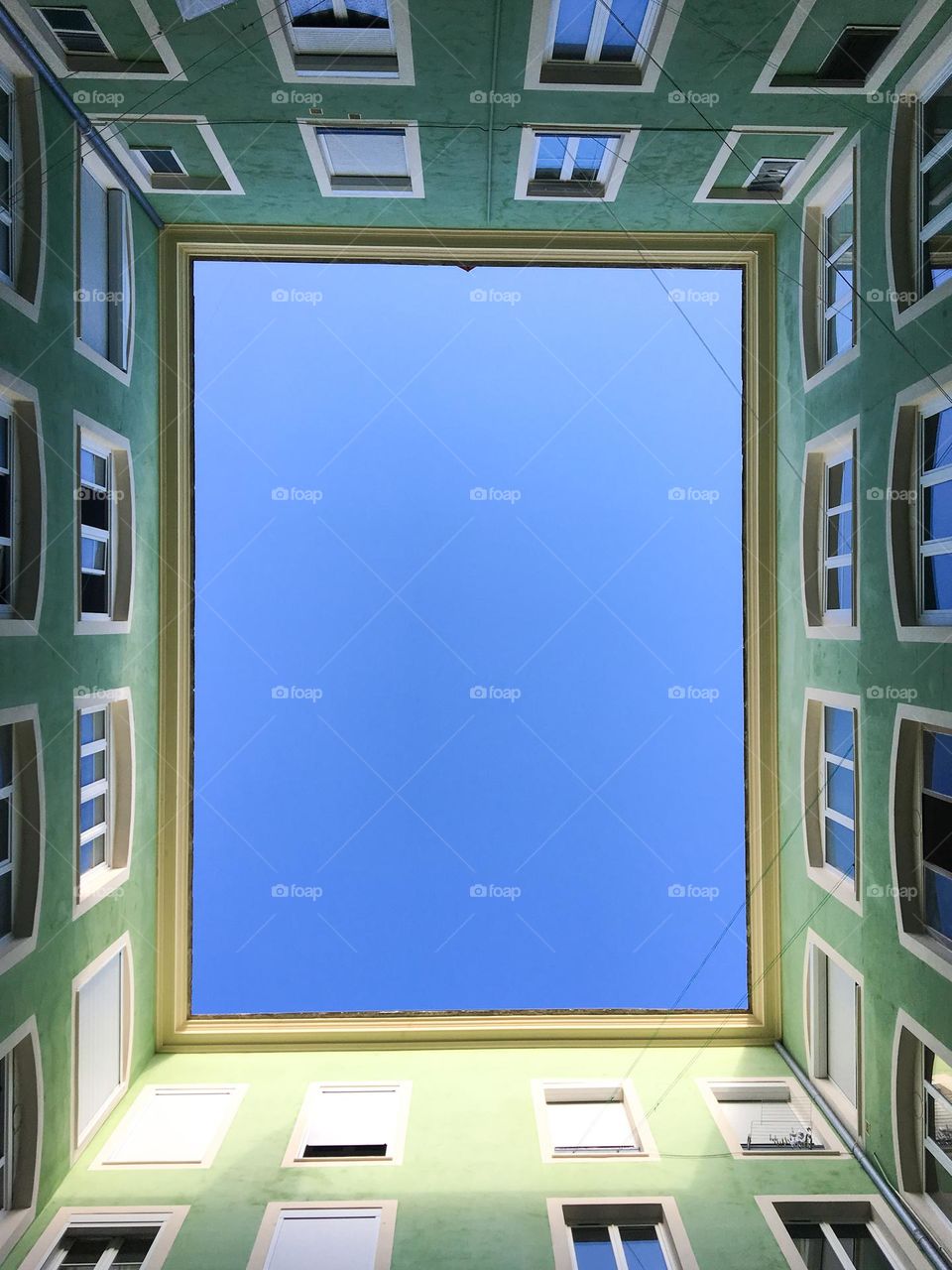 View when you look above: windows of a building with a blue sky
