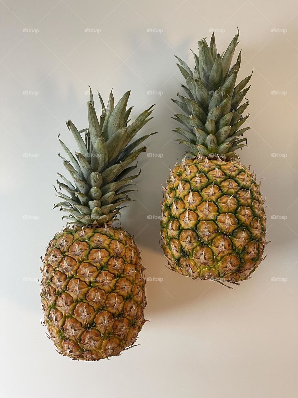 Pineapples from above against clear background, healthy eating, vitamin fruit, tropical fruit 