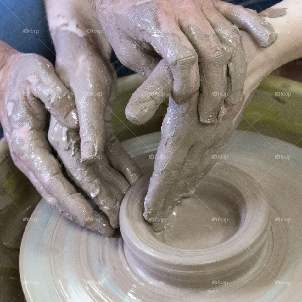 Hands on a pottery wheel