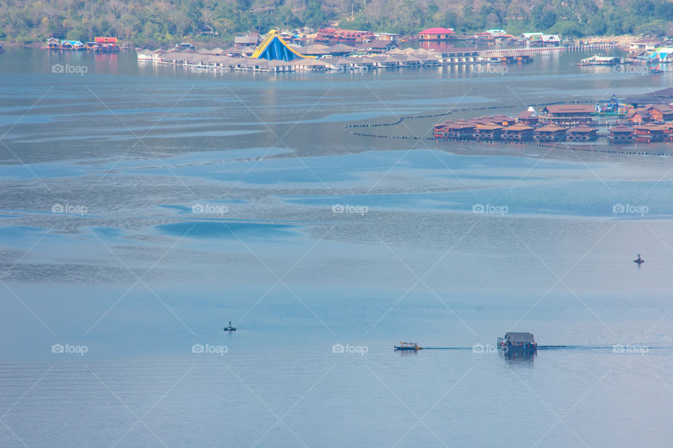 The ships were dragging a houseboat in the dam at Sri Nakarin dam , Kanchana buri in Thailand.