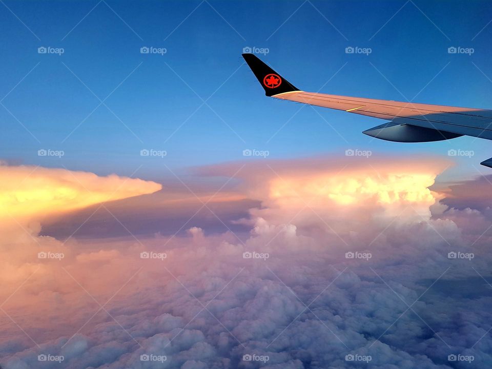 Airplane flying at sunset