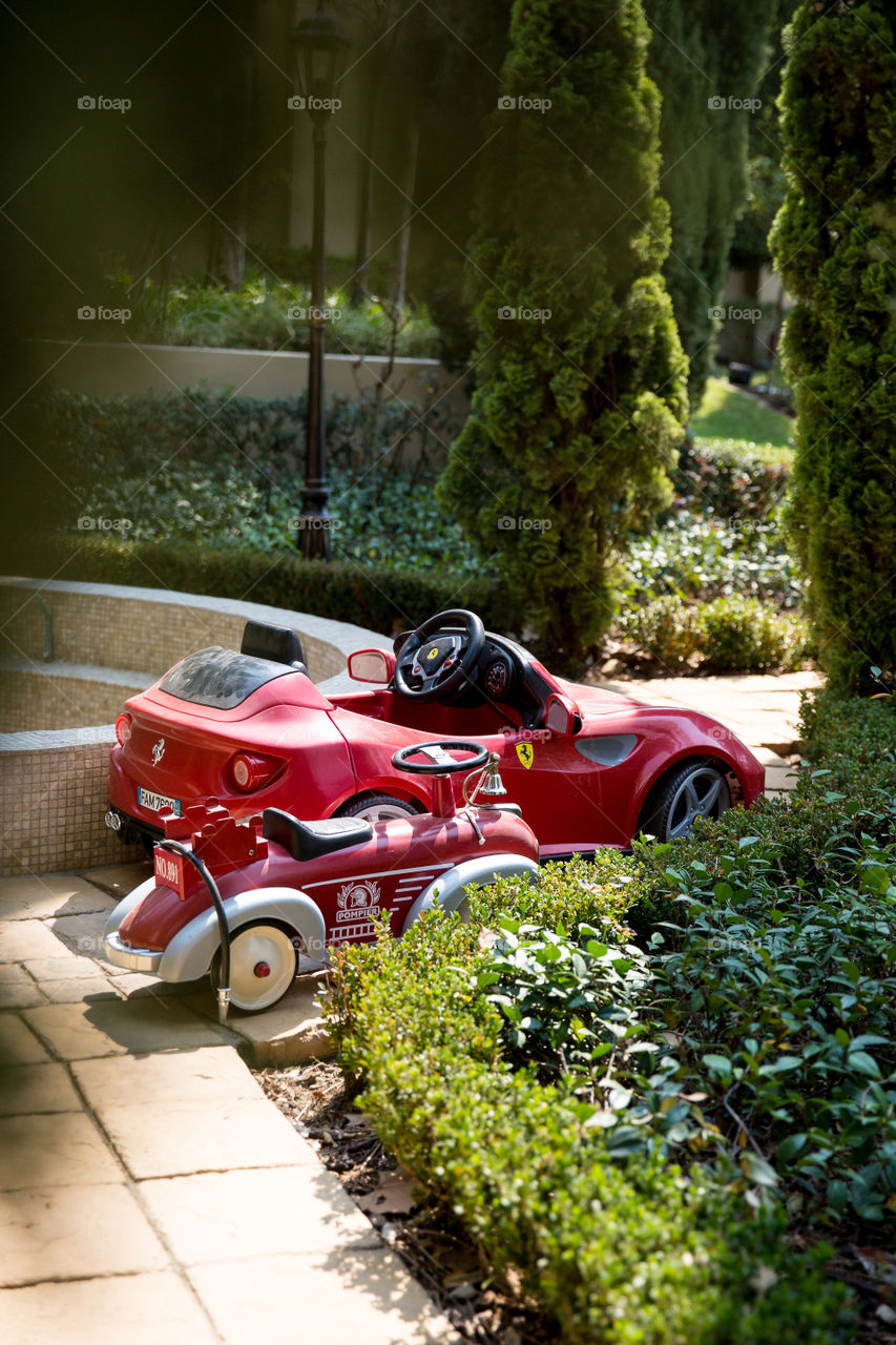 Toy cars are fun to play with and to use to get around. Image of red toy sport cars in the garden