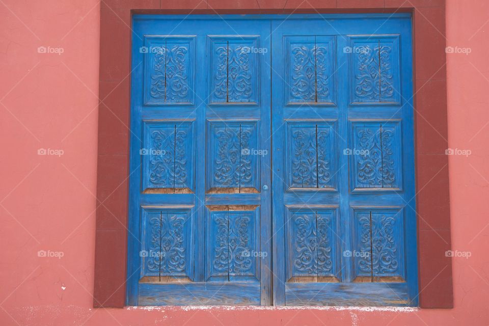 A worn blue double doorway in San Miguel de Allende, Mexico
