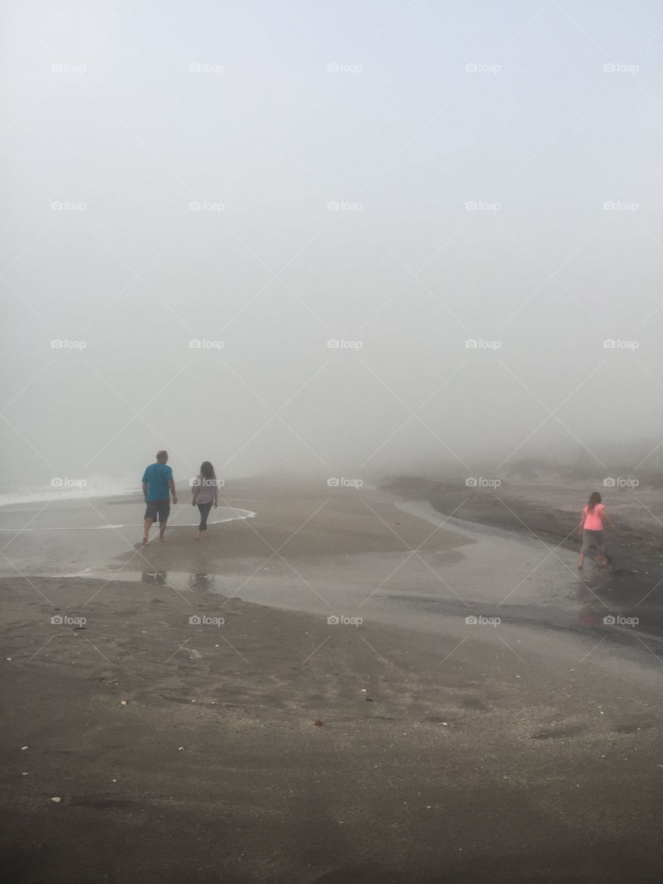 Family walking through the fog 