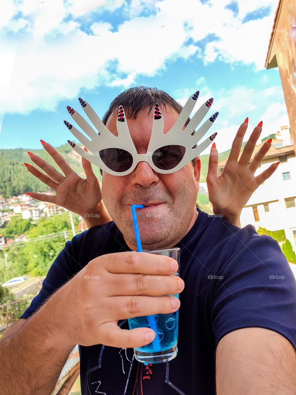 Energetic, Light-Hearted Funny Selfie with Cocktail and Sunglasses