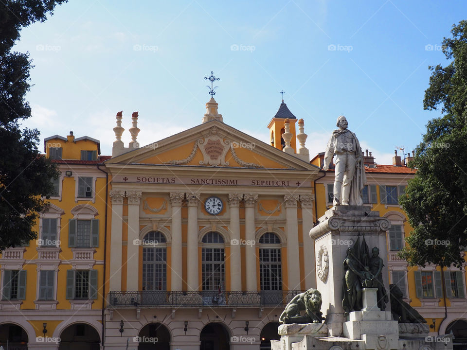 Yellow building and fountain on the Place Garibaldi in Nice, France.