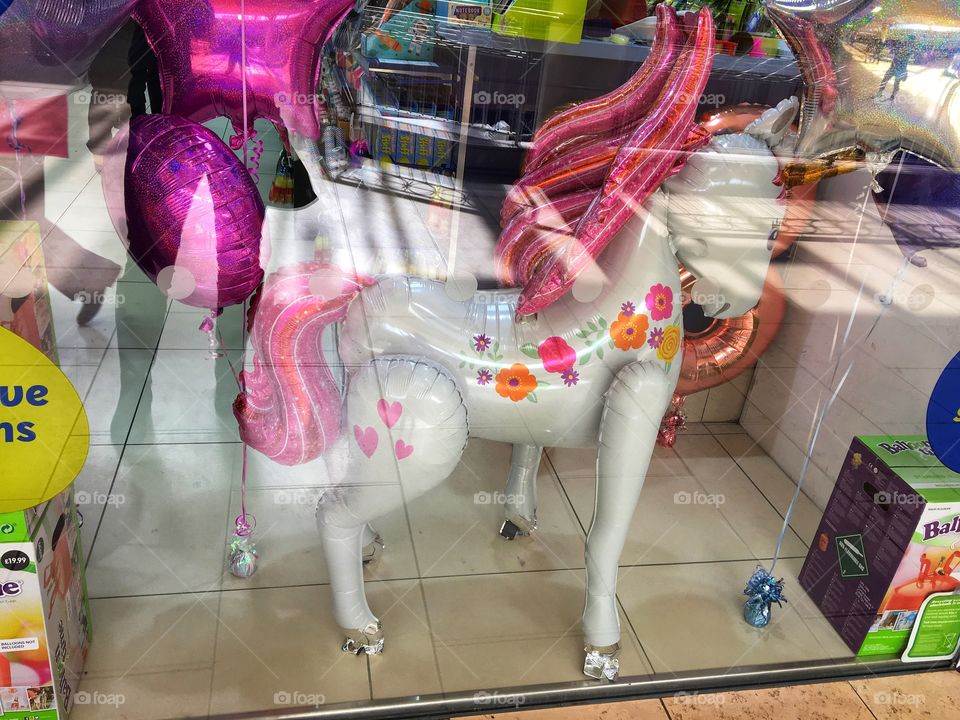 A unicorn balloon in a shop window in The Metro Centre 