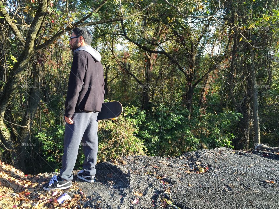Man in black . Boyfriend looking over treetops from cliff in Easton, Pa
