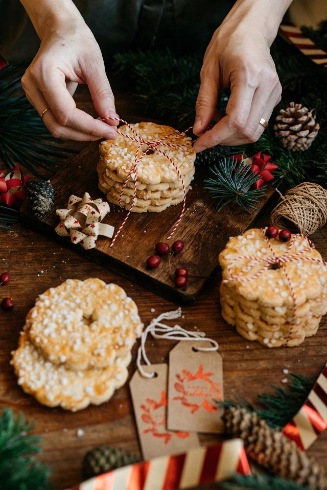 Woman packing homemade butter cookies for winter holidays.